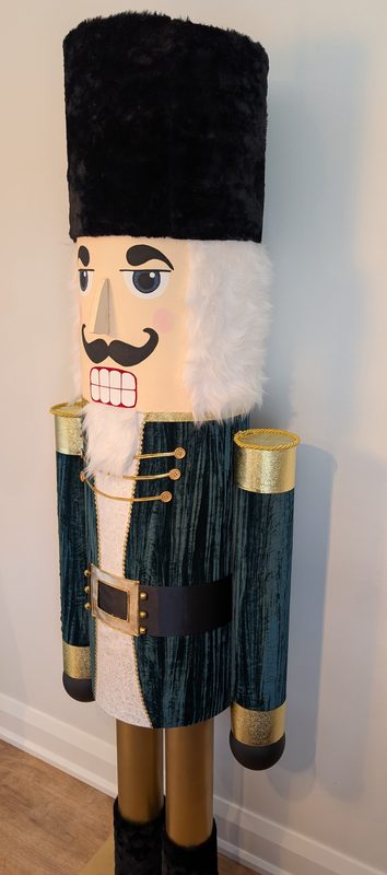 Three-quarter view showing the hand-painted face and faux-fur beard